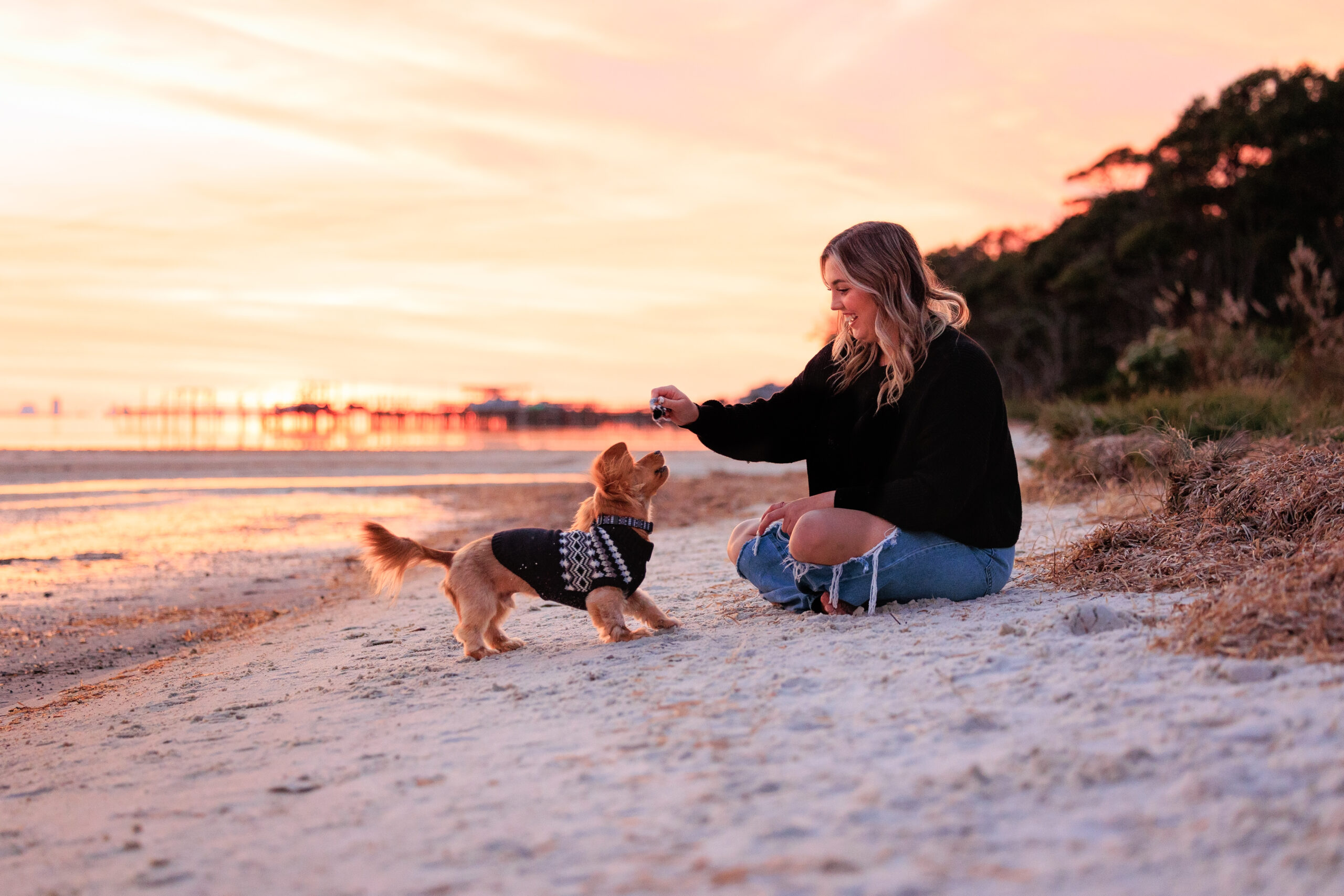 Woman & dog playing on Pensacola beach.